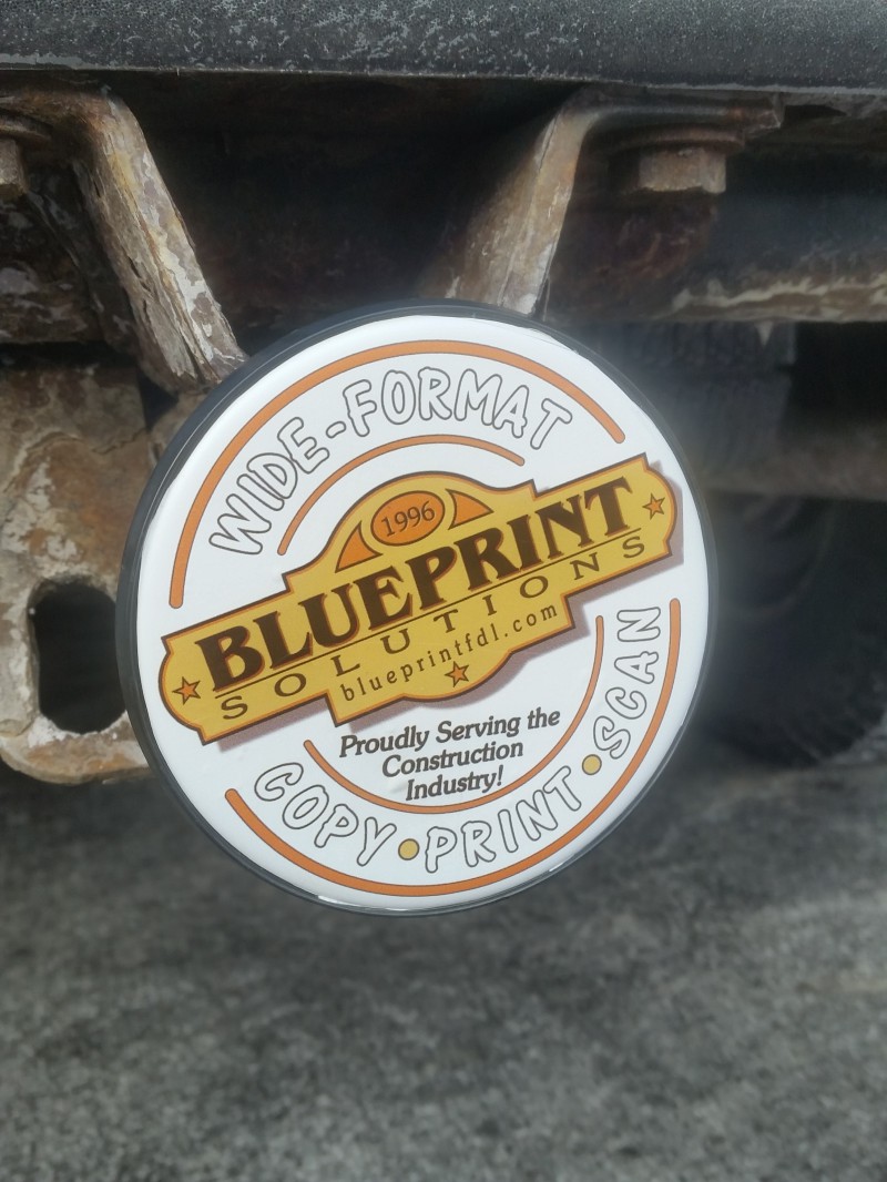 Round Blueprint Solutions sticker on a trailer hitch