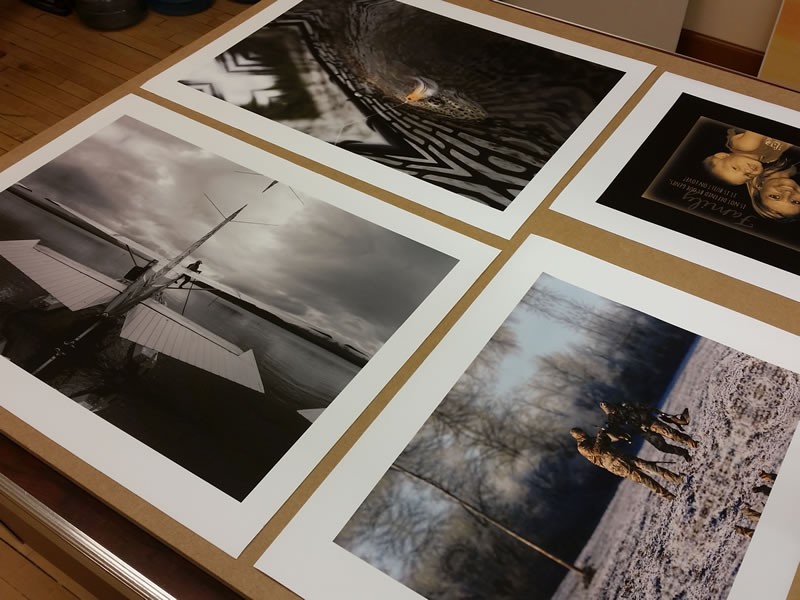 Black and white photo prints laid out on a table