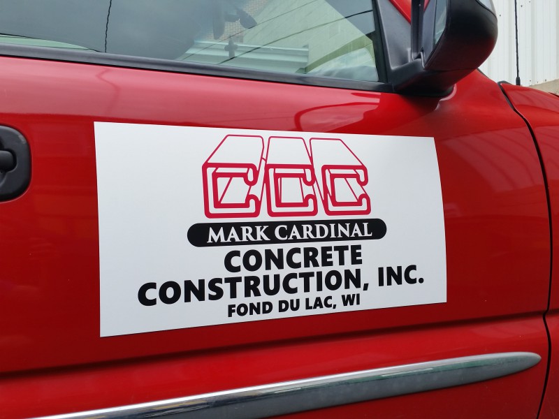 Magnetic door sign on a red construction truck