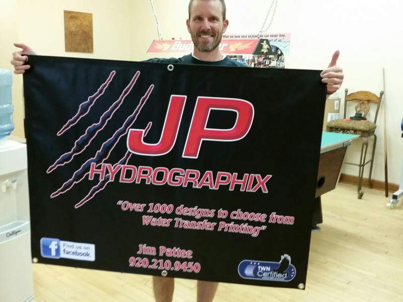 Customer holding a JP Hydrographix banner