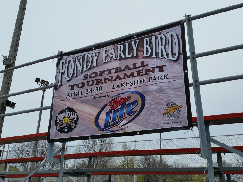 Fondy Early Bird softball tournament banner on a fence