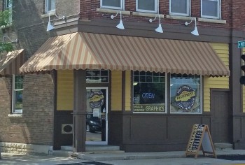 The Blueprint Solutions shop entrance under a striped awning